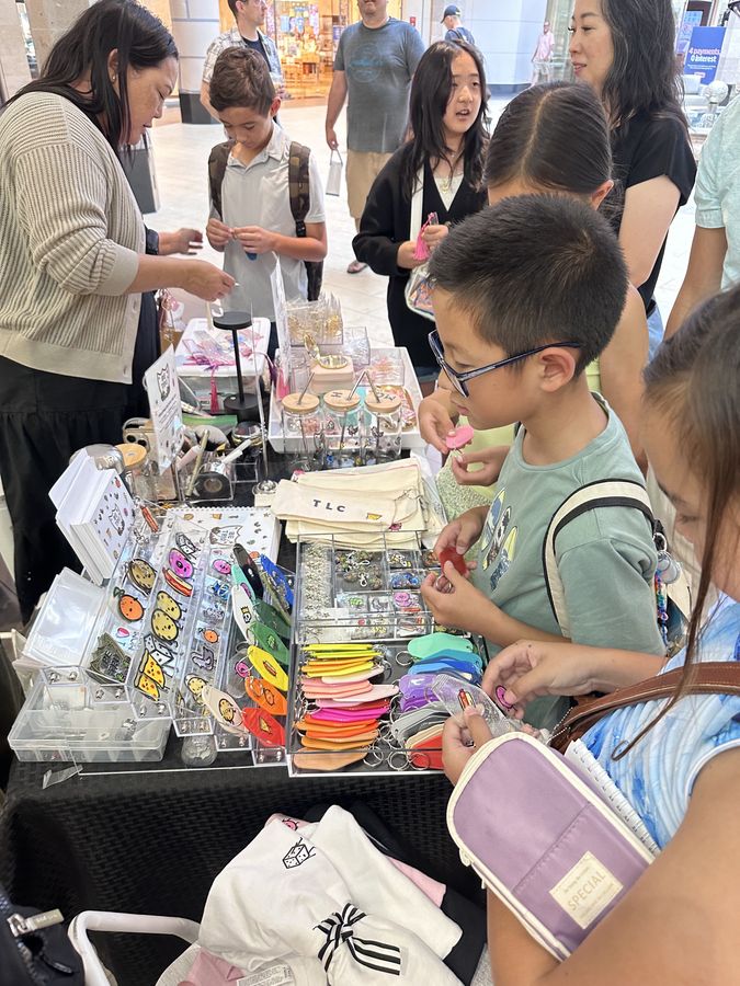 Crowd browsing charms at the Lululemon pop-up