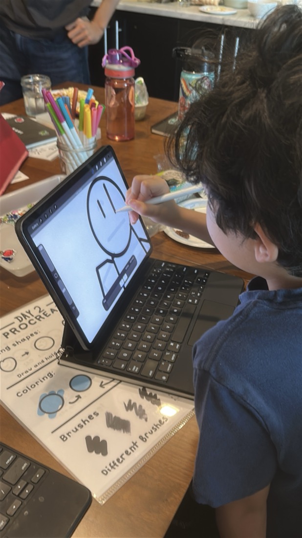 Manu drawing a character on his iPad in Procreate