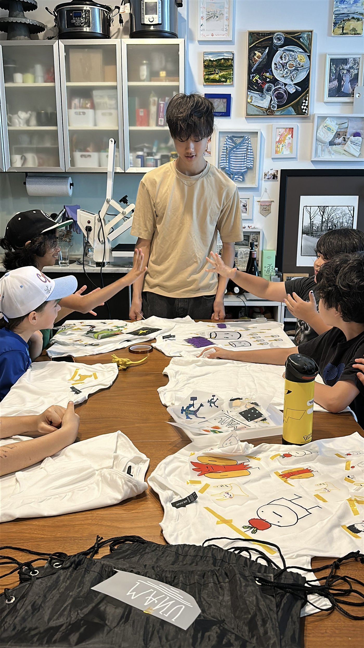 Truman with the workshop group and their finished t-shirts